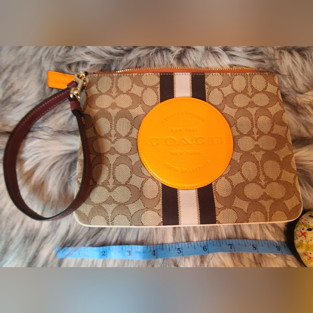Coach Signature Leather Dempsey Tan and Orange Wristlet.